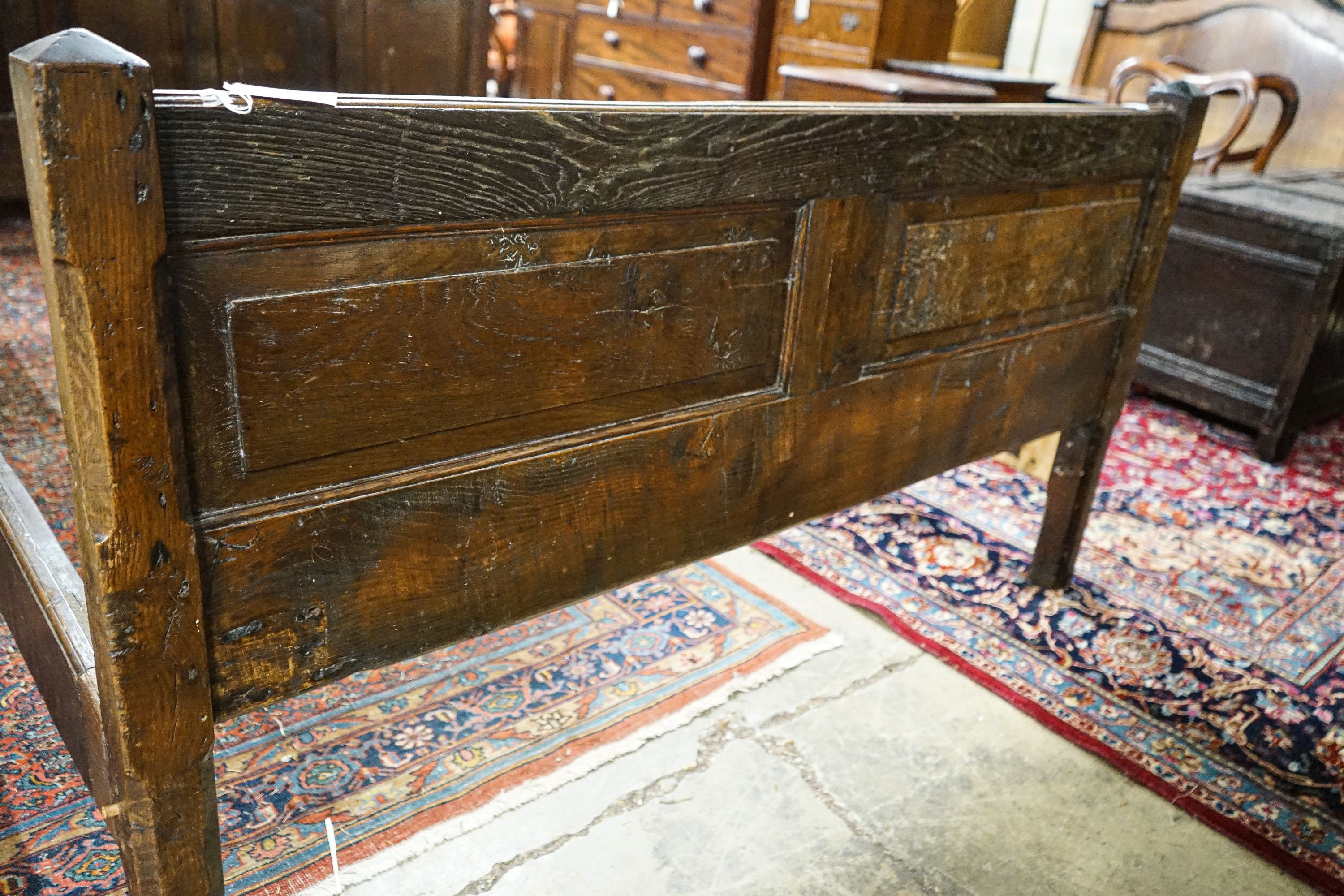 A 17th century style panelled oak bedstead, width 158cm, length 208cm